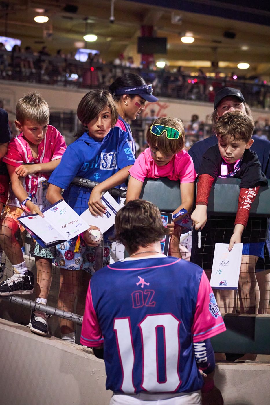 Lucky Llamas player signing autographs for kids