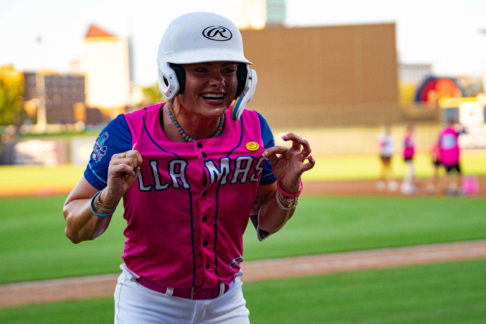Lucky Llamas player in pink and navy uniform celebrating at the plate