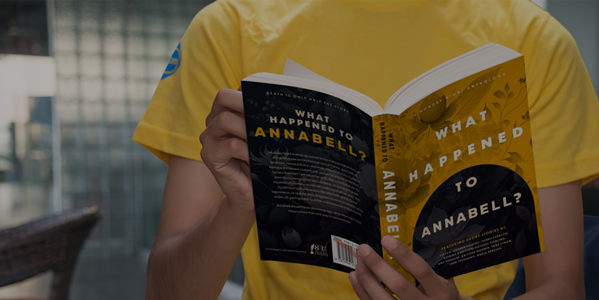 Person in a yellow shirt reading a paperback book titled "What Happened to Annabell?"